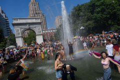 People jump in the fountain at Washington Square Park as they celebrate pride, Manhattan, New York. 26 June 2022.