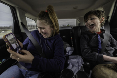 Boston and Malcolm have a moment of joy while playing with Snapchat filters in the car after leaving a doctor’s visit in Rochester, New York, on 12.6.22. Moments like these are not rare in the Alaimo household. Despite the immense responsibilities and emotional burden carried by the caretakers of the family, they always find a way to laugh.