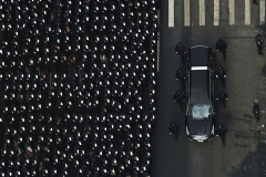 NYPD officers line up and and salute as the hearse drives past during the processional of fallen NYPD officer Wilbert Mora following the funeral at St. Patrick's Cathedral on February 01, 2022 in New York City. Officer Mora, and his partner Officer Jason Rivera, were fatally wounded when a gunman ambushed them in an apartment as they responded to a family dispute.