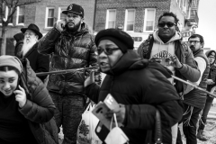 A diverse group of people gather at the edge of a crime scene where a man was shot and killed in the Brooklyn borough of New York, New York, USA, 31 January 2022. New York City saw 1,877 shootings in 2021, the highest number of shootings in decades, and New York City Mayor Eric Adams recently released a plan for the city to address rising rates of gun violence.