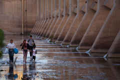 People cross into the U.S. through gap in the border wall in Yuma