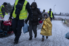 Ukrainian refugees are escorted by police after crossing the border during snowfall to Medyka, Poland. 09 March 2022. As of January 2023 there are around 8 million Ukrainian refugees outside of the country as the war approaches its one year anniversary.
