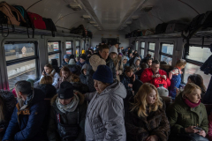Ukrainian refugees on board an evacuation train from Lviv, Ukraine, to Przemysl, Poland. 13 March 2022. As of January 2023 there are around 8 million Ukrainian refugees outside of the country as the war approaches its one year anniversary.