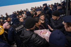 Refugees from Uzbekistan attempt to board a bus taking them to the airport after being evacuated by the Uzbekistan Embassy from Ukraine. Korczowa, Poland. 02 March 2022. As of January 2023 there are around 8 million Ukrainian refugees outside of the country as the war approaches its one year anniversary.