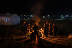 A mix of Nepali and Indian students and workers who fled Ukraine huddle around a fire to stay warm after crossing the border in Medyka, Poland. 28 February 2022. As of January 2023 there are around 8 million Ukrainian refugees outside of the country as the war approaches its one year anniversary.