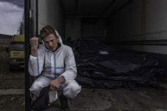 A volunteer body collector looks distressed while transporting corpses of civilians from the graveyard where authorities were investigating war crimes to the local morgue where families could make funeral arrangements in Bucha, Ukraine, on 4.12.22. Among the dead were a collection of charred bodies where one could distinctly see a man’s face frozen in terror, the curves of a woman’s body, and the full cheeks of a child. The horrors of Russian atrocities are so gruesome that even those accustomed to death could not conceal their grief.