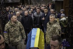 A large group of soldiers and civilians attend the funeral of Mykola Dmytrovych in Starychi, Ukraine, on 3.16.22. The majority of the small, rural village came out in solidarity, showing unity in war and the collective grief of this loss on the whole community.
