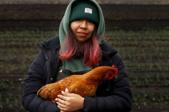 Jennifer Angel, 19, holds Canela, a chicken that has become a family pet, at her families farm in Goshen, N.Y. April 10, 2022. Jennifer and her family, who live in Brooklyn, own sixteen acres of farmland in Goshen where they grow produce that they sell at farmer's markets throughout New York City. The family, originally from Mexico, are among a small number of people of color in New York State who have taken up farming. People of color make up approximately one percent of farmers both in New York State and nationwide.
