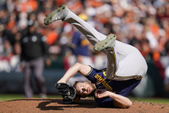 Milwaukee Brewers starting pitcher Adrian Houser rolls on his back after catching a ball hit by Baltimore Orioles' Austin Hays during the fourth inning of a baseball game at Oriole Park at Camden Yards, Monday, April 11, 2022, in Baltimore.