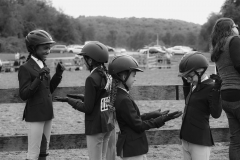 EQUESTRIAN DREAMS - After COVID put a damper on the competitions of previous years, the Chicory Meadow Farm IEA (Interscholastic Equestrian Association) team, compared to the Bad News Bears because the team often lost, was unusually diverse and even included a boy, weren’t on to win some of the top prizes by the end of the season. To pass the time, the Chicory Meadow Farm team plays a hand-clapping game together when they waited to compete in the IEA Hunt Seat Show Sunday, September 25, 2022 at Meadow Creek Farm in Pleasant Valley, NY.