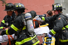 Emergency Paramedics and Firefighters perform CPR on a fire victim during a  high rise fire at 333 East 181 Street in the Bronx, New York on January,9, 2022. The fire left 19 dead and 45 others seriously hurt.The incident led to federal building codes being changed after smoke traveled from the 2nd floor to the 25th floor. Most of the victims were found in the stairwells.