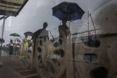 Visitors were reflected on the glass that protects Steam Locomotive at Jangdan Station, (Registered Cultural Heritage No. 78) on display at Imjingak, Gyeonggi-do, South Korea on on July 23rd, 2022. Imjingak is a park located on the banks of the Imjin River along the tracks of the former Gyeongui Train Line outside the city of Paju, South Korea. The park has many statues and monuments regarding the Korean War. [Story first published July 26, 2023]According to Paju City: This locomotive is a symbol of the division of South and North Korea, which was left unattended in the DMZ for over half a century after being bombed and derailed during the Korean War.In 2004, it was registered as a cultural property to preserve it as evidence of a painful history, and then, with the support of POSCO, the rust was removed.