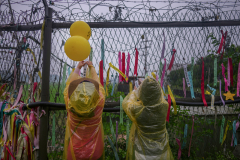 Visitors hanging ribbons with messages calling for peace and reunification at a Imjingak park near the DMZ in Gyeonggi-do, South Korea on July 23rd, 2022. Imjingak is a park located on the banks of the Imjin River along the tracks of the former Gyeongui Train Line outside the city of Paju, South Korea. The park has many statues and monuments dedicated to the Korean War. [Story first published July 26, 2023]