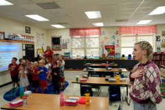 Eden Hoeffling, 17, pledges allegiance as she tutors at Skyline Elementary School in Sedalia, Mo., on September 26, 2023. Eden tutors in the same classroom, with the same teacher as when she was a student (the room was chosen due to the proximity to the school nurses office as a child.) Despite the risk of getting sick due to her immune disorder, Hypogammaglobulinemia, Eden still tutors. “They’re worth it because they’re adorable and I like working with them,” she said.