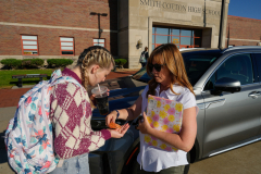Eden Hoeffling, 17, is given medication by her mother Alena Hoeffling, before the start of her day at Smith-Cotton High School in Sedalia, Mo., on September 26, 2023. Alena had driven to the school to give Eden the medication which she’d forgotten at home. Eden says she’d be lost without her mother, “I’m just a 12 year-old in a 18 year-old’s body, I don’t know what’s going on most of the time.”