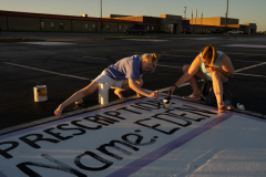 Eden Hoeffling, 17, and her mother Alena Hoeffling, paint Eden's senior car parking spot at Smith-Cotton High School in Sedalia, Missouri, on September 24, 2023. They painted the word 'Prescription' "as a nod to her medical condition,” said her mother, Alena.