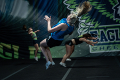 Eden Hoeffling (center), 17, flips through the air during practice with her team at Eagle Elite Cheerleading gym in Columbia, Mo., on September 28, 2023. Eden was scouted and offered a College Cheerleading Scholarship to William Woods University.