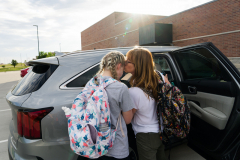 Eden Hoeffling, 17, is kissed by her mother Alena Hoeffling, outside of Smith-Cotton High School in Sedalia, Mo., before Eden is driven by her father to cheerleading practice in Columbia, on September 26, 2023. When asked how the family cope with the challenges associated with supporting Eden, her mother Alena said “Once we had Eden she turned out to be the glue who held it all together. She’s the center of our life now.”