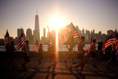 JERSEY CITY, NJ USA - AUGUST 19, 2023 -  To start the event, people jog a mile in Liberty State Park along the Hudson River as the sun rises in the morning.