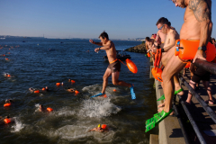 JERSEY CITY, NJ USA - AUGUST 19, 2023 -  People jump into the Hudson River from Liberty State Park in Jersey City. The 6th annual Navy Seal Foundation New York City Seal Swim.