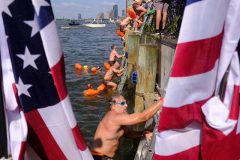 NEW YORK, NY USA - AUGUST 19, 2023 -  People climb out of the Hudson River after their swim from Jersey City. The 6th annual Navy Seal Foundation New York City Seal Swim.