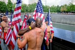 NEW YORK, NY USA - AUGUST 19, 2023 -  At the end of the event a pair of law enforcement officers hug while in front of the South Tower Pool.