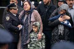 NYPD officer Adeed Fayaz’s widow holds the folded NYPD flag from his casket along side other family members outside the Makki Masjid Muslim Community Center Thursday, Feb. 9 2023 in Brooklyn, New York.