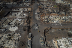 Aerial view shows a member of the Fire Department walking in a neighbourhood destroyed by wildfire in Lahaina, Maui, Hawaii. 14 August, 2023. The death toll from the wildfire that devastated the historic Maui town of Lahaina reached 100, making it the deadliest in the U.S. in more than 100 years.