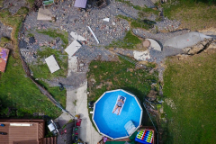 Wendy Ashenfalder took a break in her swimming pool in her flood-ravaged Bangor yard after cleaning out her flooded basement on July 20, 2023. Storms caused devastating flooding throughout the region on July 16, 2023.