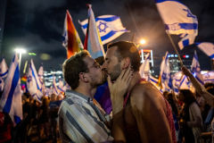 Two protestors kiss during a weekly rally against the Israeli government’s judicial overhaul on June 03, 2023 in Tel Aviv, Israel. This is the first weekly protest during Pride month. Protests against the Netanyahu government, which is in its 22nd week, began after the administration proposed an overhaul of the judiciary that would limit the Israeli Supreme Court's ability to review and strike down laws that it deems unconstitutional. On June 2nd, 17 protesters were arrested in Caesarea outside the prime minister's house, sparking further outcry and action during the weekly protest. Critics say the changes will undermine judicial independence and threaten Israel's democracy.