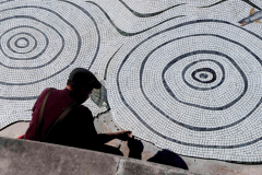 A worker sets tile in a fountain restoration at a park In Yonkers, New York, October 4, 2023.