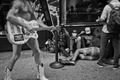July 31, 2023.  Surreal scene, Times Square street performer Robert John Burck, better known as the “Naked Cowboy” made an appearance at the Roosevelt Hotel from nearby Times Square.  Newly arrived migrants at the Roosevelt Hotel last night. The hotel is an intake site. The city is running out of room as it looks outside the city.