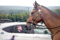 WILKES-BARRE, PA   USA - AUGUST 17, 2024 -   A pair of Pennsylvania State Police equestrian units patrol the parking lot outside the Mohegan Sun Arena hours before the former President and Republican Presidential nominee Donald Trump holds his rally there as a decal of Donald Trump is displayed on a parked car.