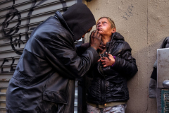 A man plunges a hypodermic needle into the neck of a woman at the entrance to the Third Avenue–149th Street station in The Hub on Sunday, December 29, 2024 in the Bronx, N.Y.  The Hub, situated at the intersection of East 149th Street and Third Avenue, is one of the Bronx's busiest shopping districts but has also emerged as an open-air drug market and a central point in the area's fentanyl crisis. According to the New York City Department of Health and Mental Hygiene, Bronx residents recorded the highest overdose death rate among the 3,046 fatalities reported in 2023.