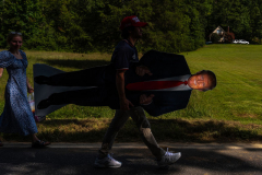 A supporter carries a stand-up of Republican presidential nominee former President Donald Trump after a campaign rally at North Carolina Aviation Museum, Wednesday, Aug. 21, 2024, in Asheboro, N.C.
