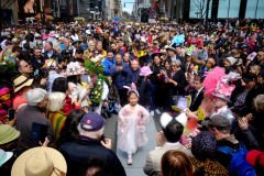 NEW YORK, NY USA - MARCH 31, 2024 - A young girl walks an impromptu small runway as Fifth Avenue is packed during the 2024 NYC Easter Bonnet Parade. The annual parade attracts thousands of people wearing their Sunday best Easter Bonnets.