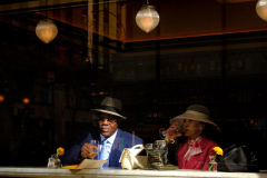 Drinks After Easter Parade NEW YORK, NY USA - MARCH 31, 2024 -  A couple relaxes over drinks at a Rockefeller Center restaurant after participating in the 2024 NYC Easter Bonnet Parade in Manhattan. People at the parade frequently dress in period dress based on the 1948 musical film Easter Parade, starring Judy Garland and Fred Astaire.