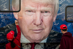 Supporters of Republican presidential nominee former President Donald Trump sign a bus before a campaign rally at the Butler Farm Show, Saturday, Oct. 5, 2024, in Butler, Pa.