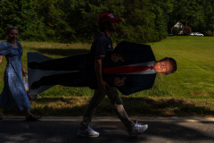 A supporters carries a stand-up of Republican presidential nominee former President Donald Trump after a campaign rally at North Carolina Aviation Museum, Wednesday, Aug. 21, 2024, in Asheboro, N.C.