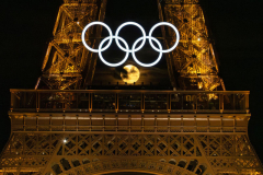 The full moon rises behind the Olympic rings on the Eiffel Tower as the city is readied to host the 2024 Summer Games in Paris, France on Sunday, July 21, 2024. The Summer Olympic Games begin July 26th, 100-years after Paris last hosted the games.