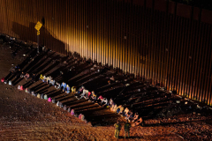Migrants cross the U.S.-Mexico border at Lukeville, Arizona