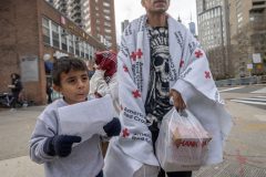 Coming to America, A Migrants Journey-After a long 2 month long journey from Guatemala, Migrant Julio Zambrano, along with his two sons Julio, 9, and Joseph, 6, try to keep warm while walking to the hotel they were assigned to in New York City, Thursday, Jan. 4, 2024