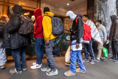 Migrants line up as they arrivie at Roosevelt Hotel in New York City, Thursday, Jan. 4, 2024.