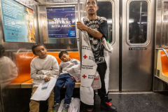 Migrant, Julio Zambrano, along with his two sons Julio, 9, and Joseph, 6, ride the E train heading to China Town in New York City, Thursday, Jan. 4, 2024 after a long 2 months journey from Guatemala.  They are now trying to find their way to the assign hotel they will be stay while in NYC.