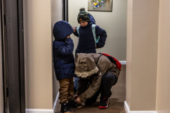 Immigrant Julio Zambrano and his two sons Cesar 6, and Julio, 9  leaving his hotel room at 5:30am to meet the requirements he’s responsible for at the immigration office on Wednesday, Jan. 31, 2024.  Julio Zambrano was turned away at immigration Tuesday despite being more than a half hour early for his appointment.