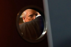 Republican presidential nominee former President Donald Trump is seen through a window in a door before speaking at a campaign event at ll Toro E La Capra, Friday, Aug. 23, 2024, in Las Vegas.
