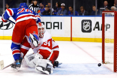 New York Rangers left wing Chris Kreider (20) scores a goal against Detroit Red Wings goaltender Alex Lyon (34) during the second period of an NHL hockey game at Madison Square Garden, Monday, Oct. 14, 2024, in New York.