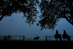 Outriders watch horses work out ahead of the 156th running of the Belmont Stakes horse race at Saratoga Race Course, Friday, June 7, 2024, in Saratoga Springs, N.Y.