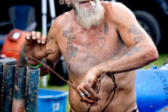 AUGUSTA, NJ USA - AUGUST 5, 2024 -  Wilbur Babcock, of Hamburg, NJ, gets wire ready to cut to ensure all the doors and hoods stay closed when the cars get hit. Drivers can also weld their doors and hoods to compete in a different class. The second night of the Demolition Derby at the NJ State Fair was held at the Sussex County Fairgrounds in Augusta.
