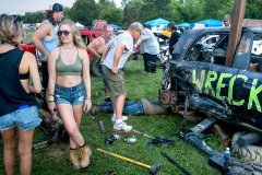 AUGUSTA, NJ USA - AUGUST 5, 2024 -  Pit crew members work on the Wreckless car while others hang out before the second night of competition. The second night of the Demolition Derby at the NJ State Fair held at the Sussex County Fairgrounds in Augusta.